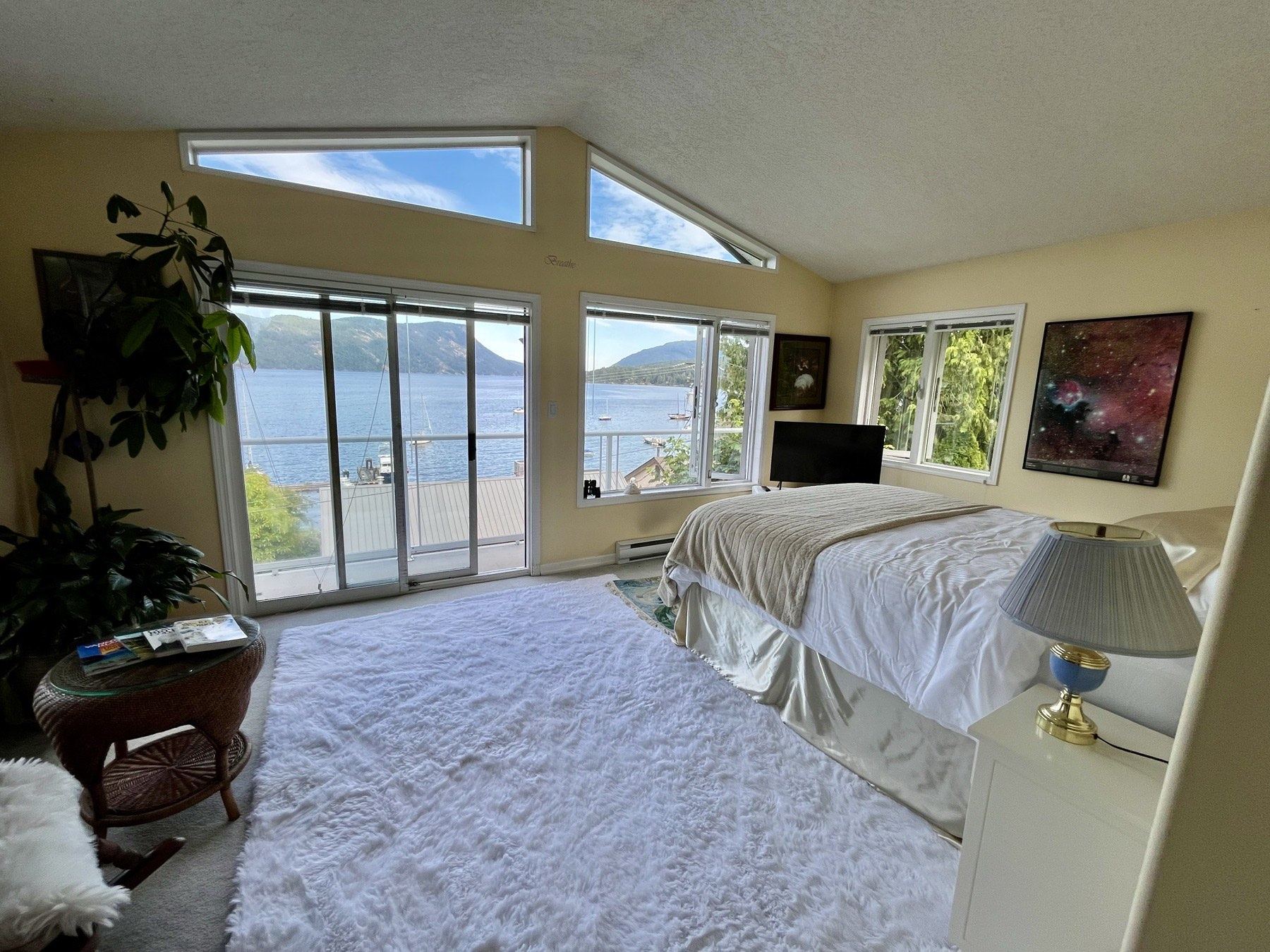 Primary bedroom with vaulted windows and panoramic ocean views